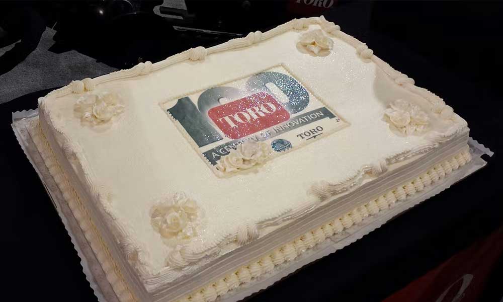 The Toro Co. celebrated its upcoming 100th birthday at ConExpo-Con/Agg 2014 in Las Vegas with a cake to share. (Photo courtesy of Brandon Jaynes/Performance Marketing, the public relations agency representing The Toro Co.)