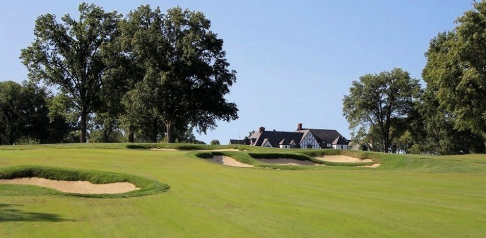 Kenwood's iconic Tudor-style clubhouse rises behind the newly renovated and dramatically re-bunkered 4th green. 