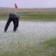 On a 2002 Dr. Joe Gruss Gets Ready to Putt through the Hail (Photo Courtesy of Dr. Bryan Williams)