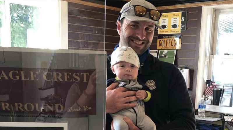 New Eagle Crest Golf Club owner Scott Battiste holds son Archie in the pro shop. The 34-year-old from Niskayuna went from head pro to owner last September