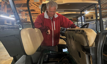 News Photo by Steve Schulwitz Course Superintendent Steve Goike checks on the motor of one of the course’s 55 golf carts while at work on Tuesday. He said for the most part, customers take care of the carts, but from time to time they get damaged from misuse.