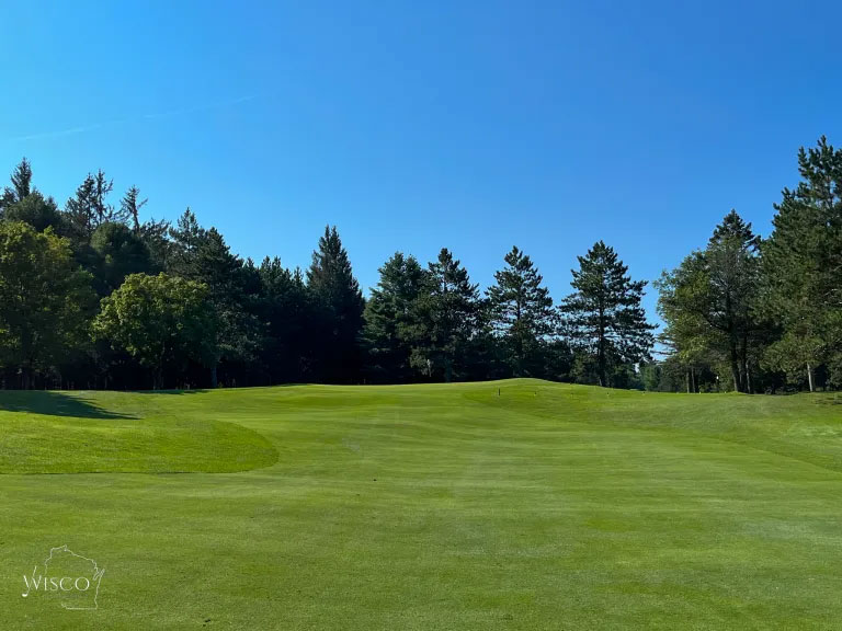 The approach to the long par 4 second should favor the left side to avoid the steep shoulder to the right that would make a chip shot daunting