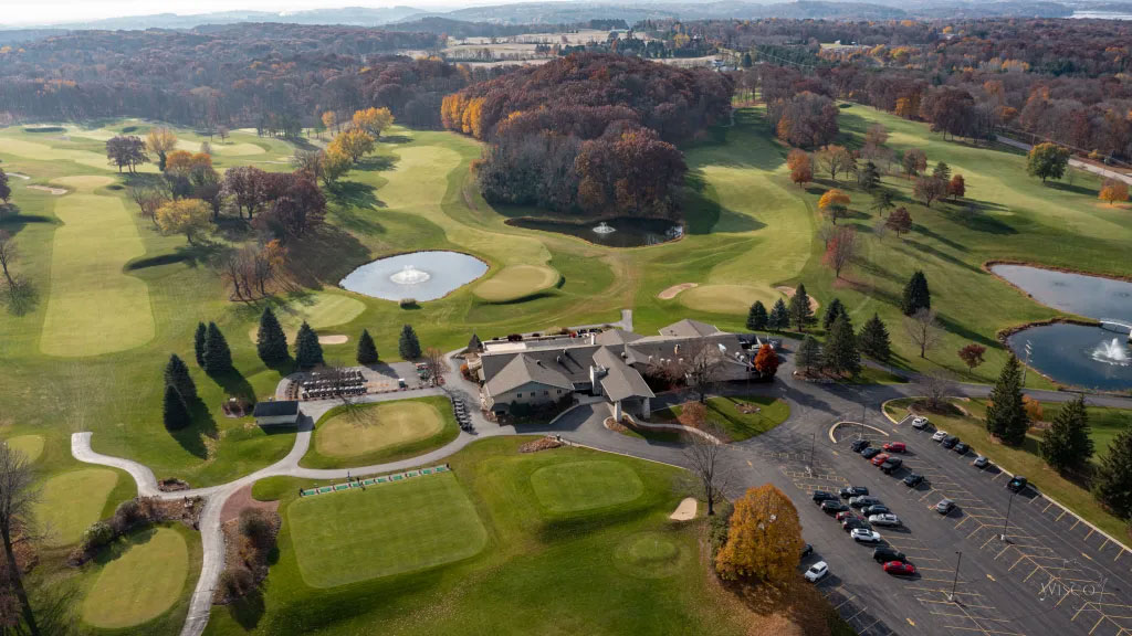 The ninth emerges from the forest, playing to a wild fairway (right-middle)