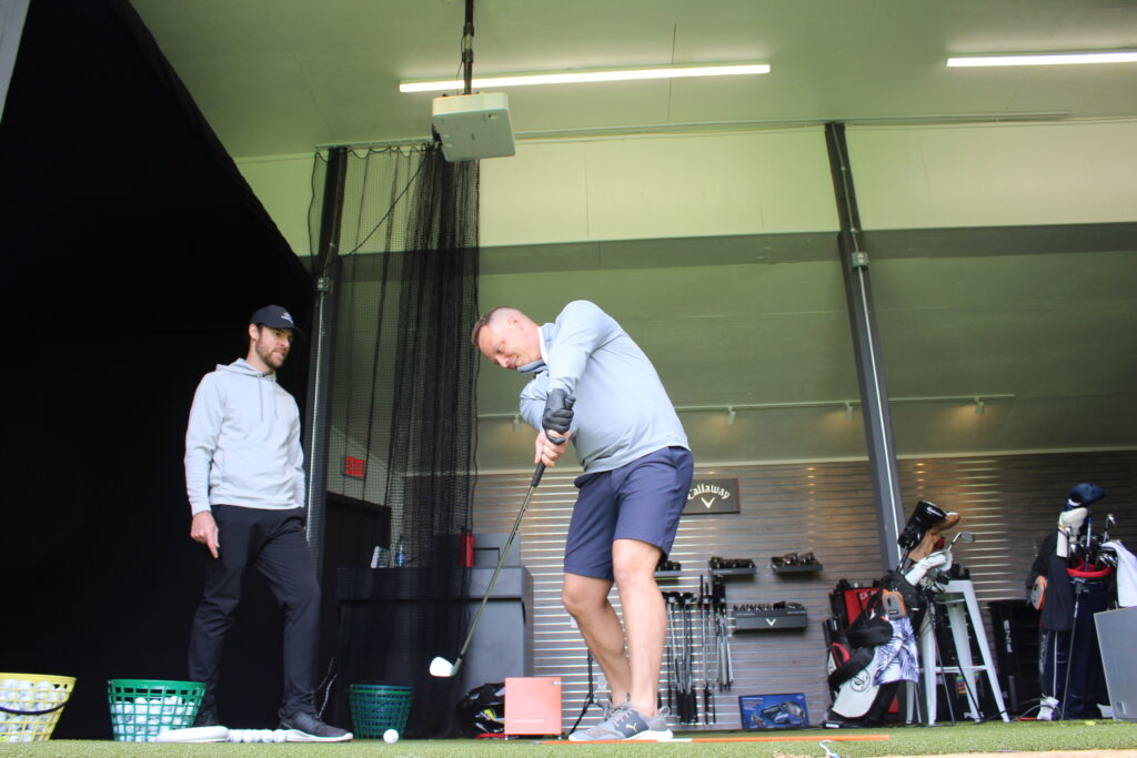 Joe Meglen (left) giving a lesson at the Linskman Golf Academy