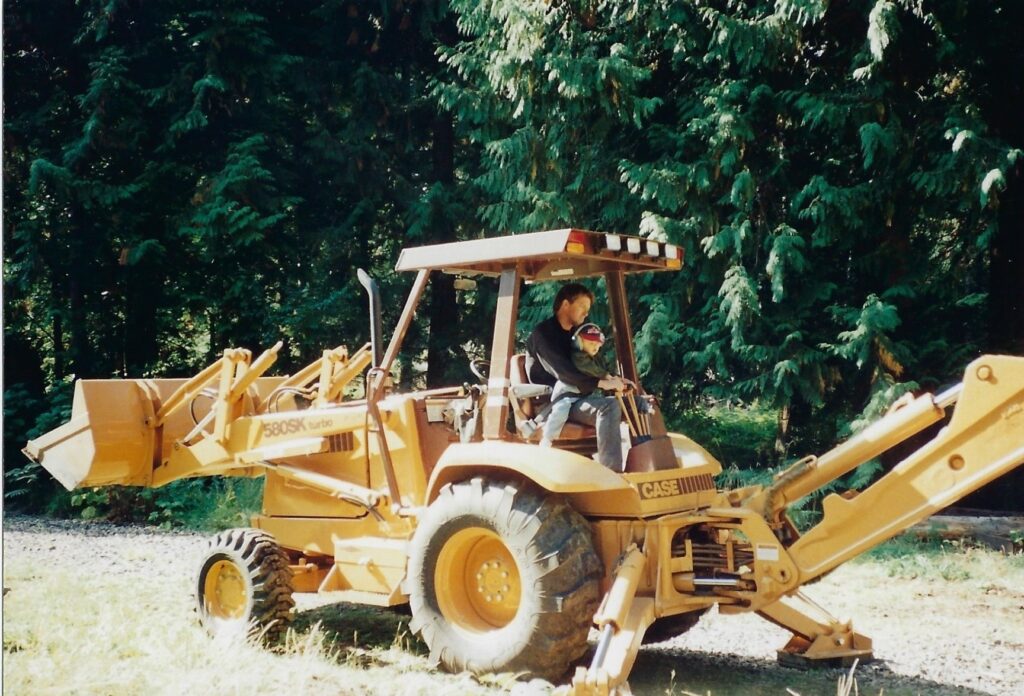 Kip and Casey on backhoe in 1994