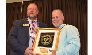 New Carolinas GCSA president, Alex Tolbert, Presents a plaque of apprciation to Chris DeVane, the Country Club of Lexington in Lexington, SC for a decade of service on the board of directors.