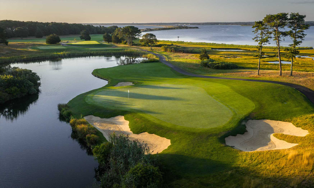 The 15th green, where heather bleeds into native marshlands framed by salt-water Sengekontacket Pond